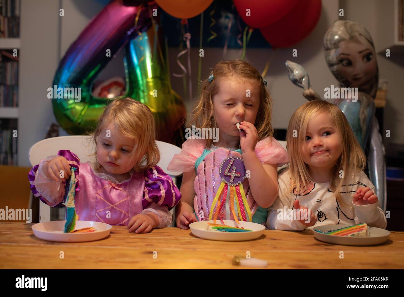 Young sisters celebrating a birthday at home during lockdown, UK Stock Photo