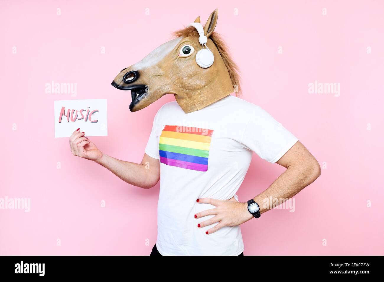 Unrecognizable man disguised with a horse's head holding a sign that says ¨music ¨.listening to