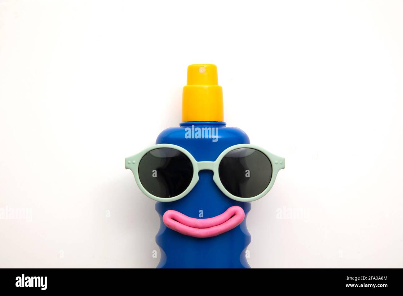 Suncream lotion bottle with a happy face and sunglasses Stock Photo