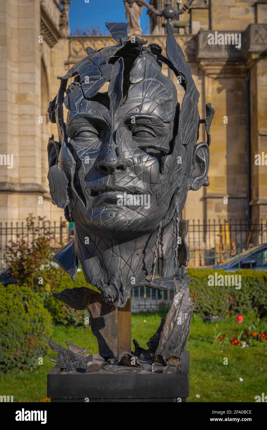 Paris, France - 03 28 2021: View of the open-air exhibition of bronze faces statues at sunset Stock Photo