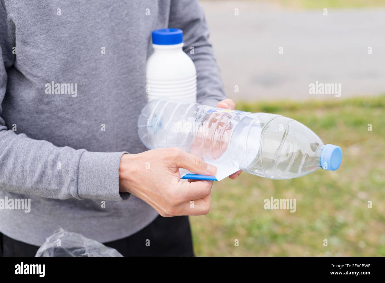 Man throwing plastic containers at recycling point. Social
