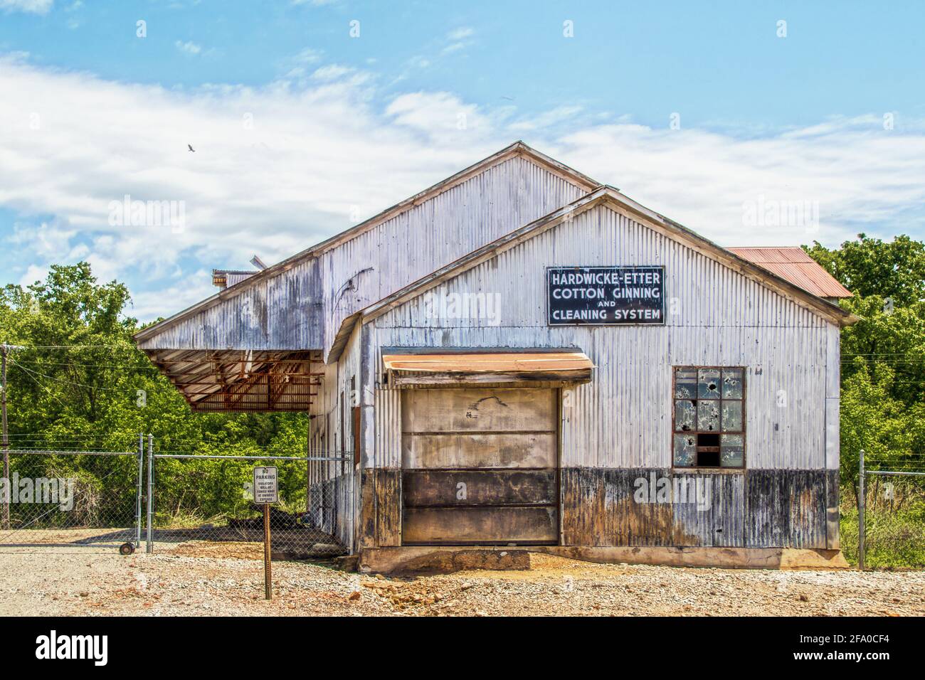 05-14-2020 Yale Oklahoma USA - Old abandoned rusty Cotton Ginning and Cleaning system corragated steel builiding with window shot out abandoned Stock Photo
