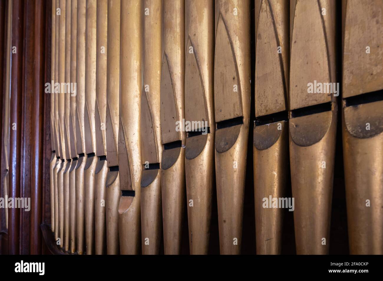 Brass flue pipes as part of a church organ in an old church in England, UK. Stock Photo