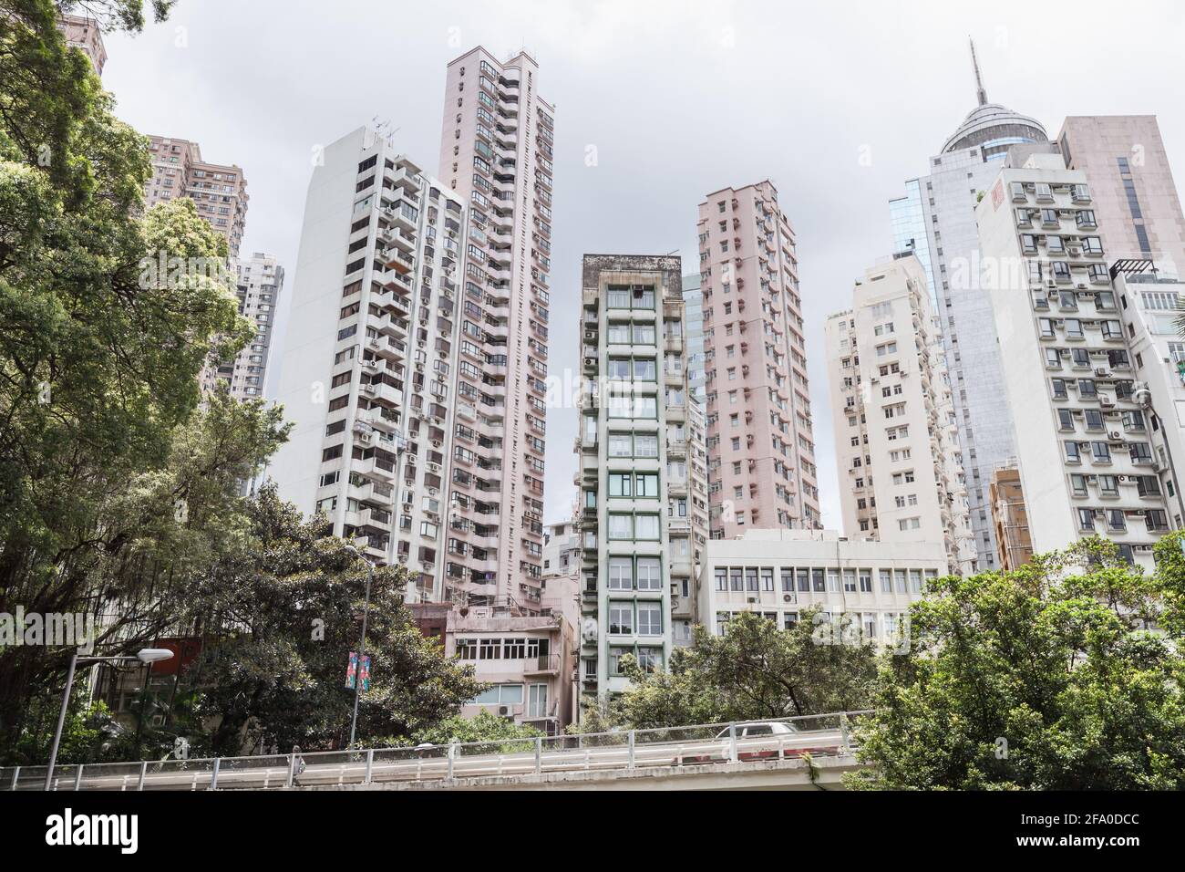 Hong Kong city skyline, tall living houses skyscrapers under cloudy sky in a summer day Stock Photo