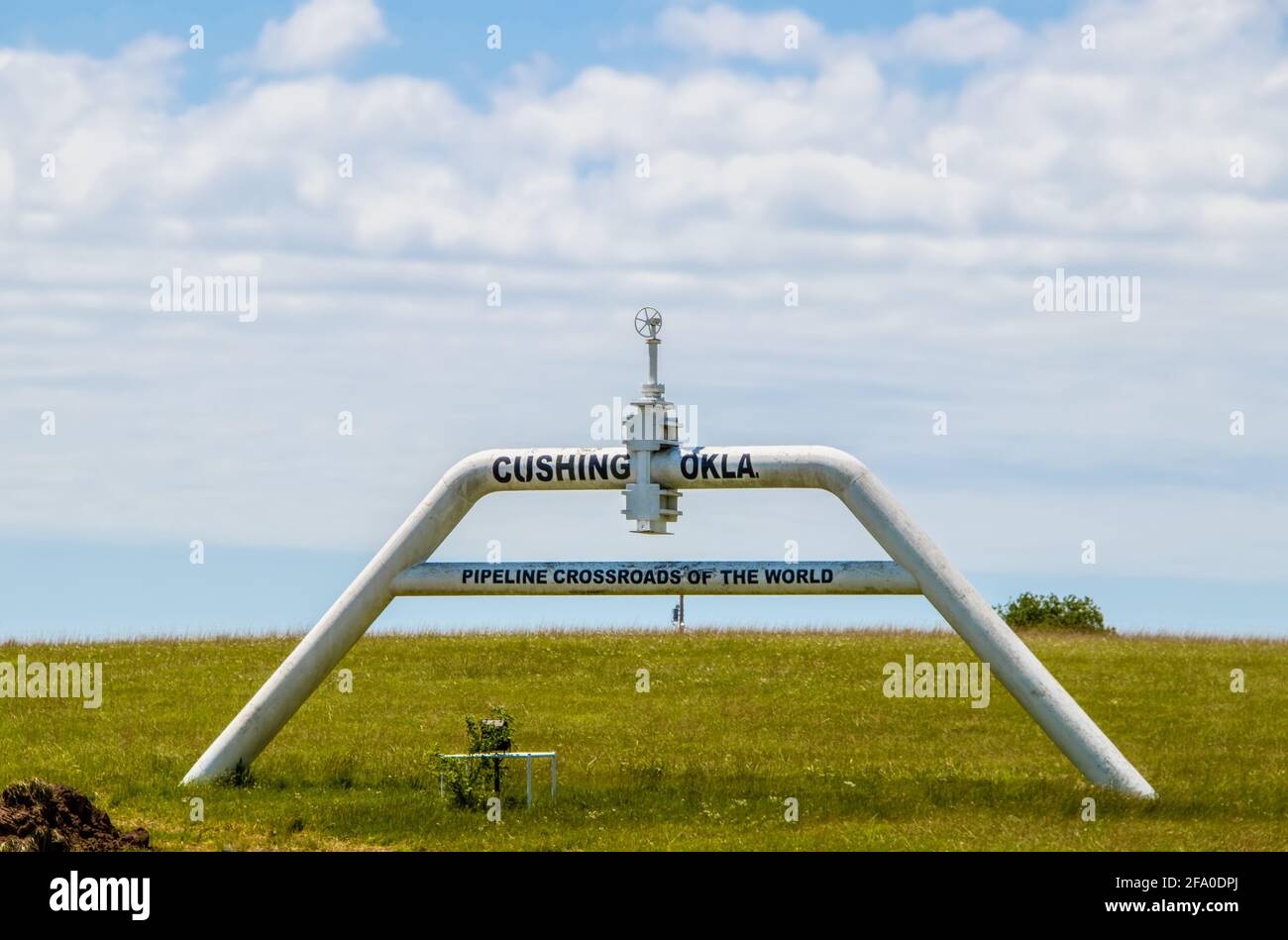 A sign made out of pipe and valves outside of Cushing OK Pipeline crossroads of the world where most WTI oil in the US is stored and traded Stock Photo