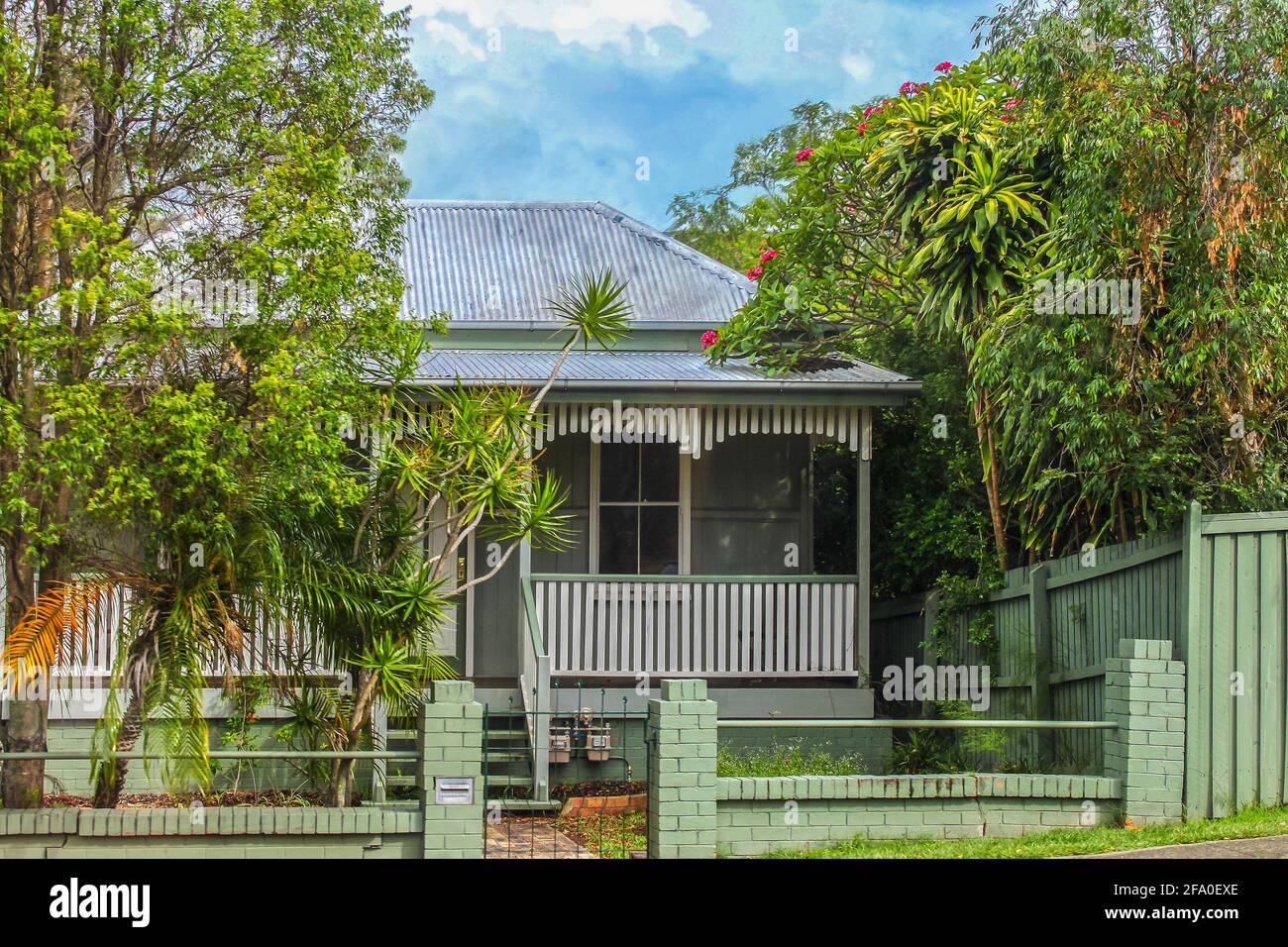 Australian house with tin roof and tropical greenery around it Stock Photo