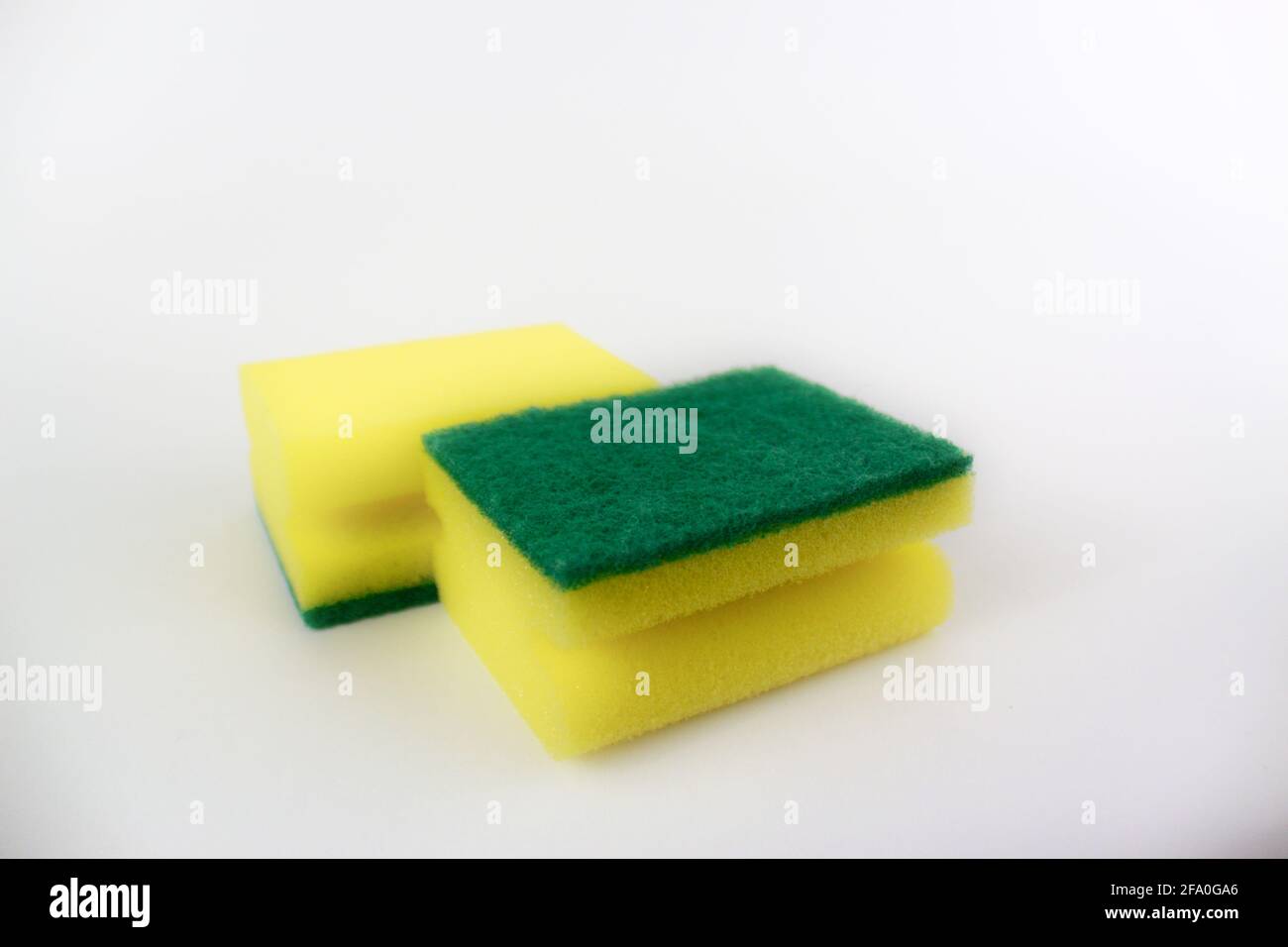 Two yellow green kitchen sponges isolated on white background Stock