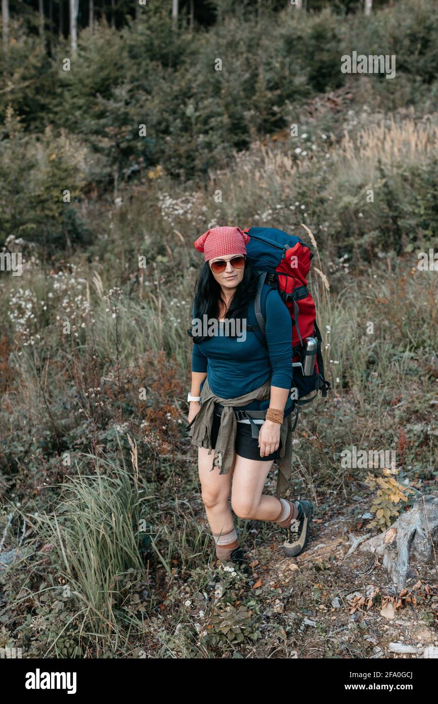 A woman backpacking alone in the wilderness. A portrait of a female hiker  hiking in the woods on her own Stock Photo - Alamy