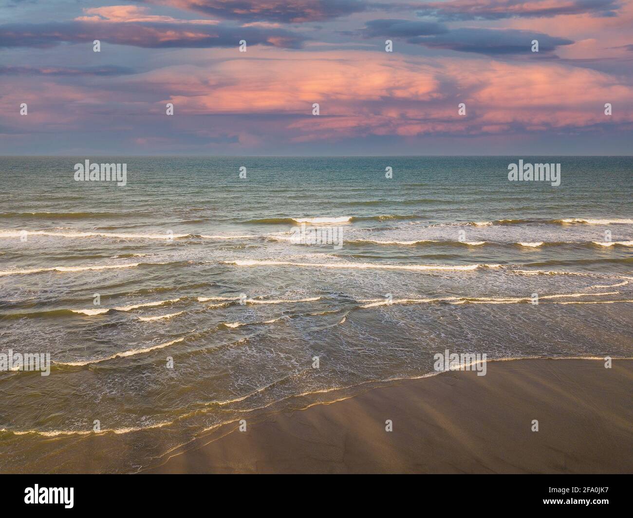 Drone aerial view of ocean waves on the beach at sunset Stock Photo - Alamy