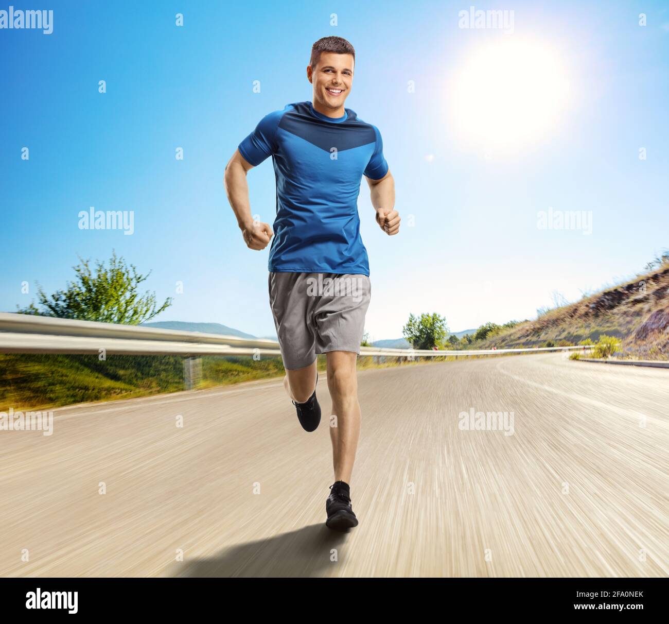 Full length portrait of a man running towards the camera on an open