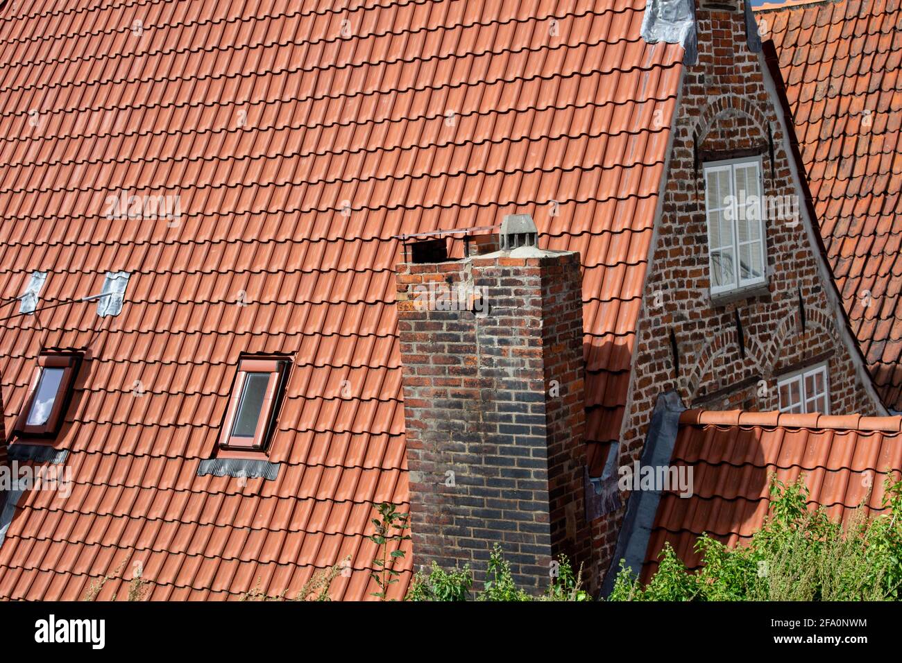 Closeup shot of a tile roof with the brick wall Stock Photo