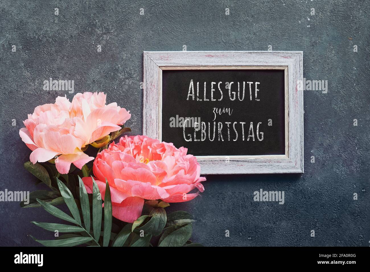 Alles gute zum Geburtstag means Happy Birthday in German language. Greeting card, peony and paper confetti, circles. Single flower and white frame on Stock Photo