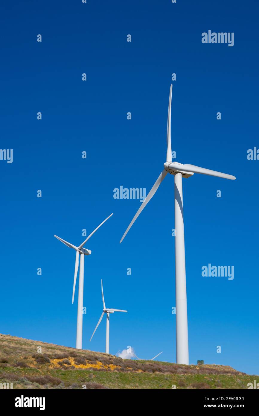 Wind turbines power nearby homes in the mountains above Los Angeles California Stock Photo