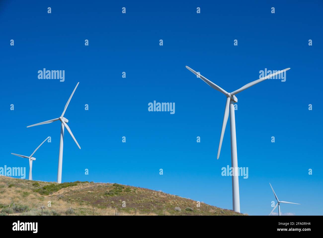 Wind turbines power nearby homes in the mountains above Los Angeles California Stock Photo