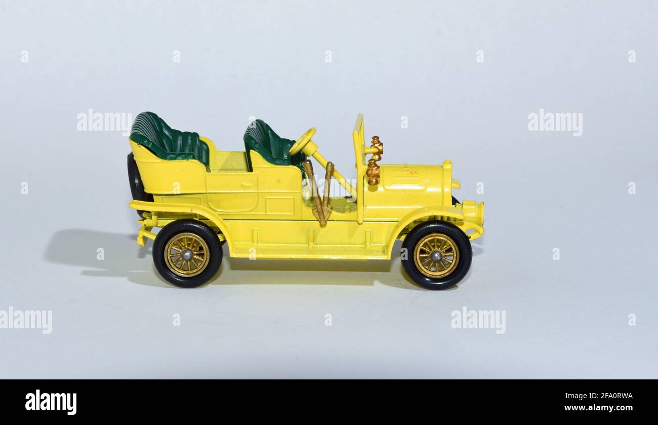 Toy diecast model of a Yellow 1904 Spyker Tourer Y-16  a Matchbox yesteryear product by Lesney with white background Stock Photo