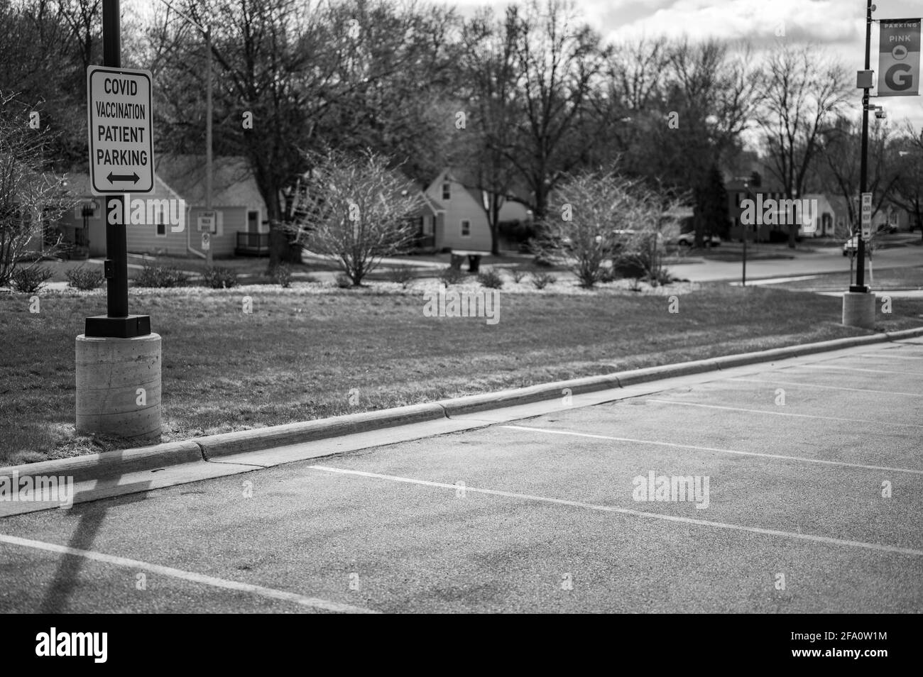 COVID vaccination sign in front of hospital with empty spaces Stock Photo