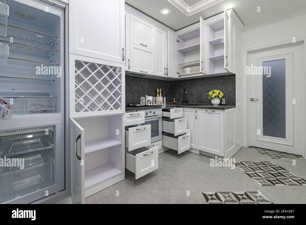 Open doors and drawers open at modern white kitchen Stock Photo Alamy