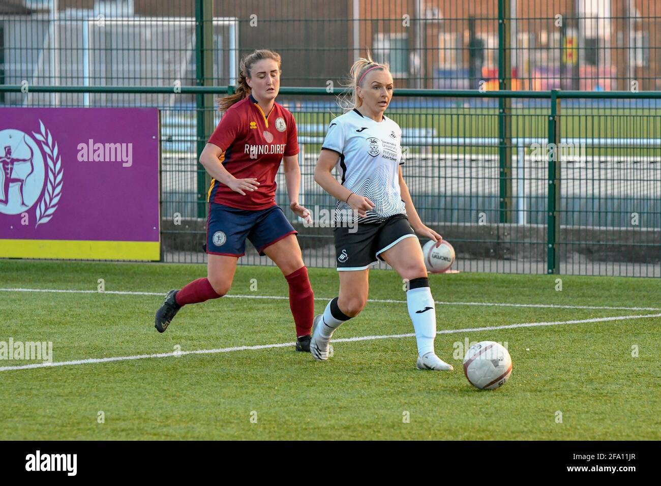 Cardiff, Wales. 21 April, 2021. Kelly Adams of Swansea City Ladies under pressure from Amy Long of Cardiff Met Women during the Welsh Premier Women's League match between Cardiff Met Women and Swansea City Ladies at the Cyncoed Campus in Cardiff, Wales, UK on 21, April 2021. Credit: Duncan Thomas/Majestic Media/Alamy Live News. Stock Photo