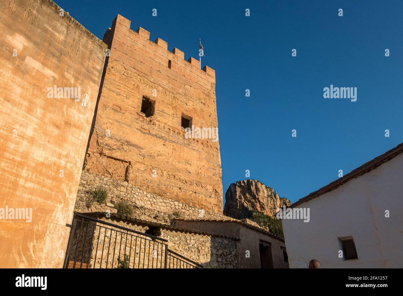 Sot de Chera Castle in Valencia, Spain, viewed from below with a deep cloudless blue sky above Stock Photo