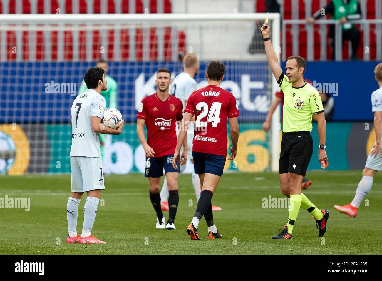 Pamplona, Spain. 21st Apr, 2021. Gonzalo Guedes (midfielder; Valencia CF) receives a yellow card from a referee during the Spanish La Liga Santander, match between CA Osasuna and Valencia CF at the Sadar stadium. (Final score : CA Osasuna 3-1 Valencia CF) Credit: SOPA Images Limited/Alamy Live News Stock Photo