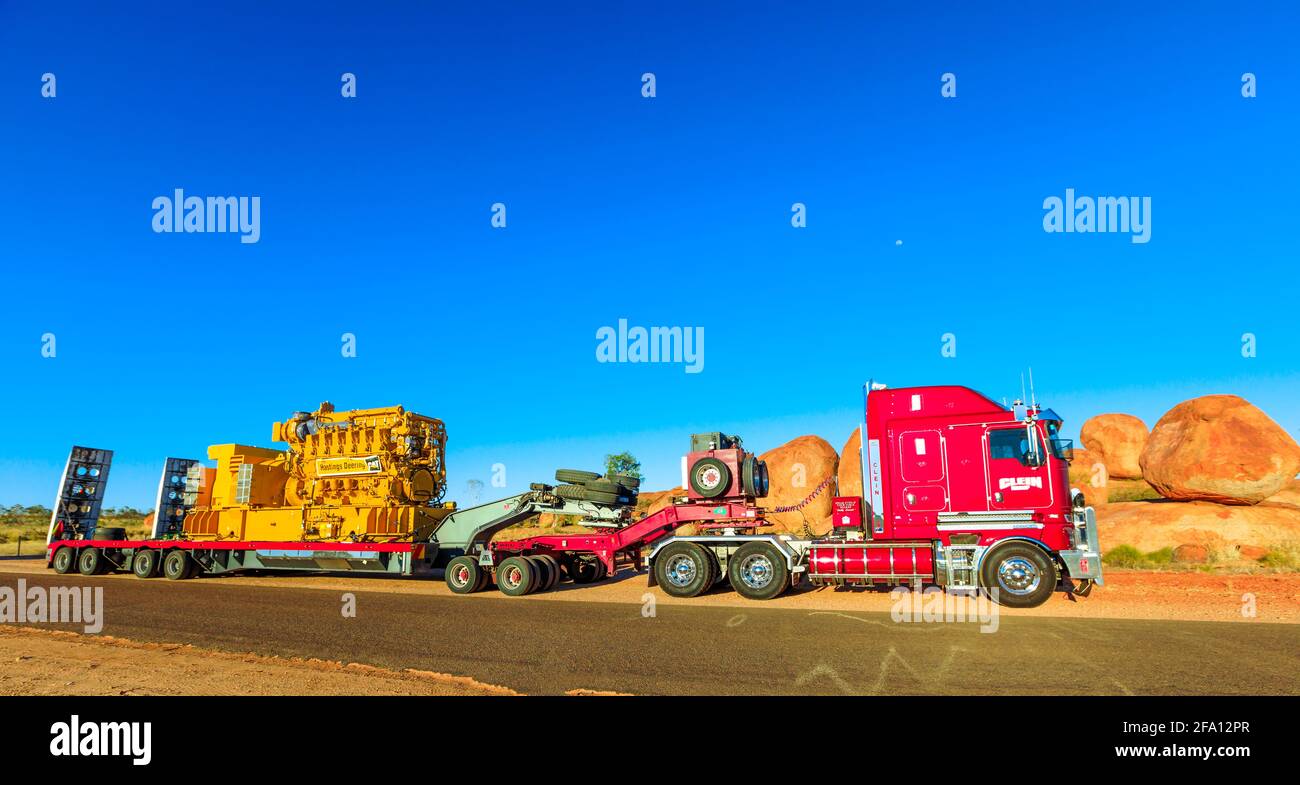 Northern Territory, Australia - August 12, 2019: red Kenworth truck of Clein Group crossing the Karlu Karlu, Devils Marbles Conservation Reserve in Stock Photo