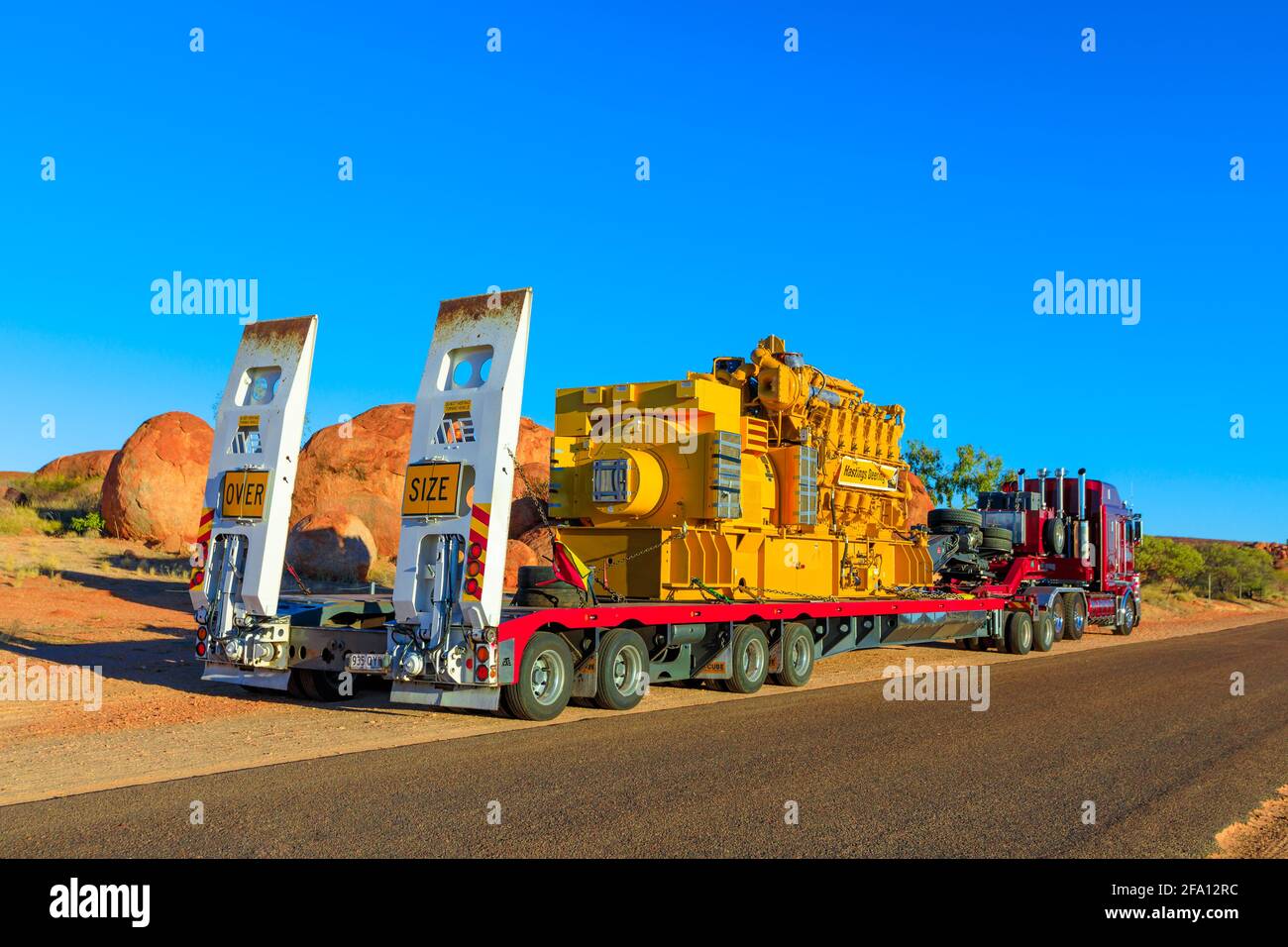 Northern Territory, Australia - August 12, 2019: red Kenworth truck of Clein Group crossing the Karlu Karlu, Devils Marbles Conservation Reserve in Stock Photo