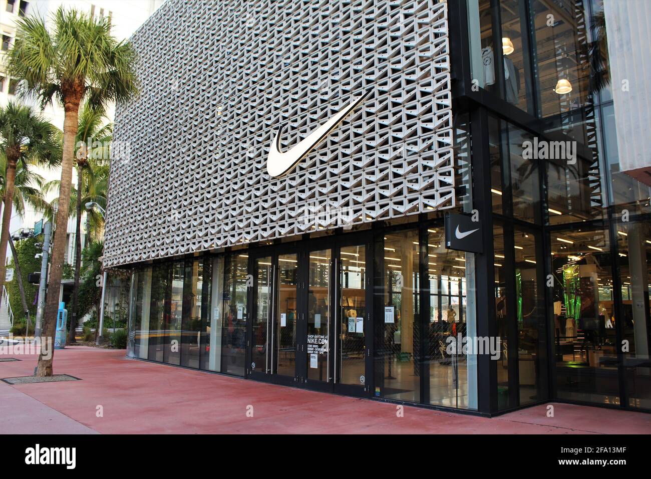 NIKE Store exterior in Lincoln Road Mall in Miami Beach, Florida. Front facade of store with palm trees. Stock Photo