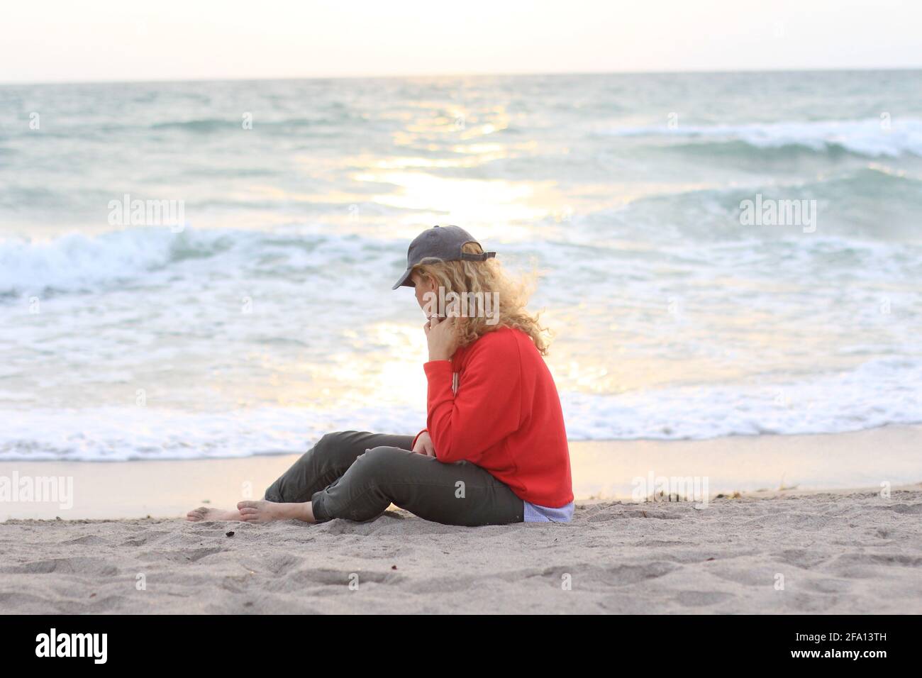 Female sitting on beach alone hi-res stock photography and images - Alamy