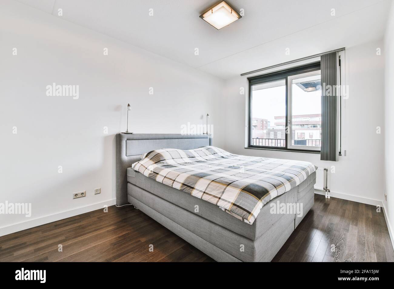 Bed near window in modern apartment Stock Photo Alamy