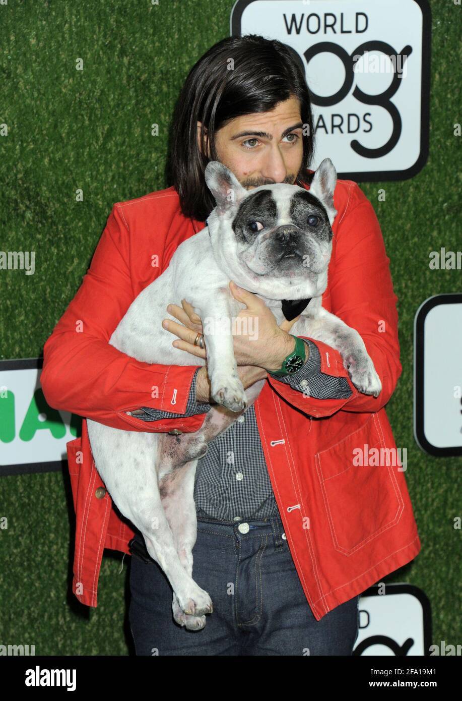 Jason Schwartzman, Dog Arrow on the green carpet during the 2016 World Dog Awards, held at Barker Hanger in Santa Monica, California, Saturday, January 9, 2016.  Photo by Jennifer Graylock-Graylock.com 917-519-7666 Stock Photo