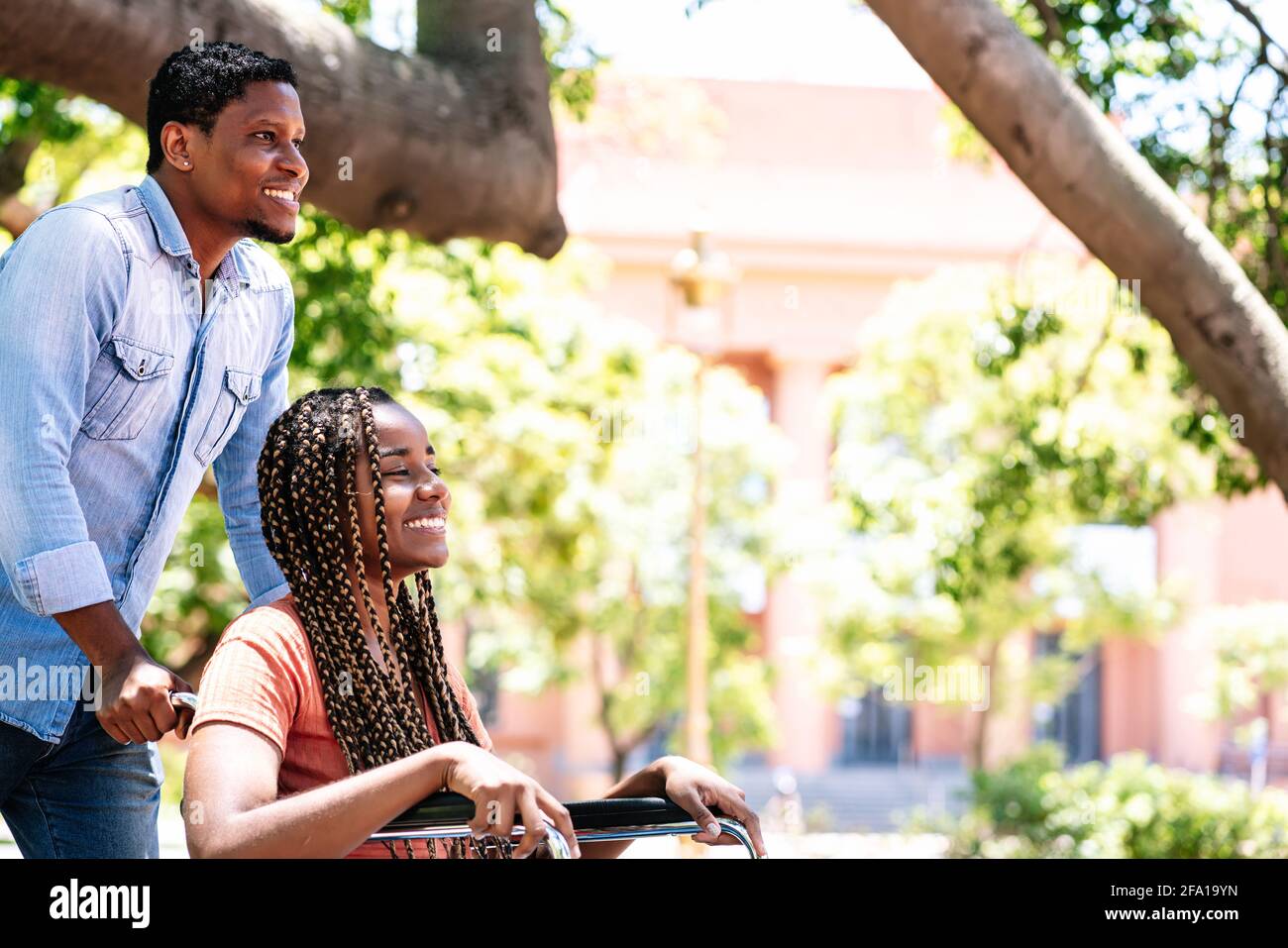 Woman in a wheelchair at the park with her boyfriend Stock Photo - Alamy