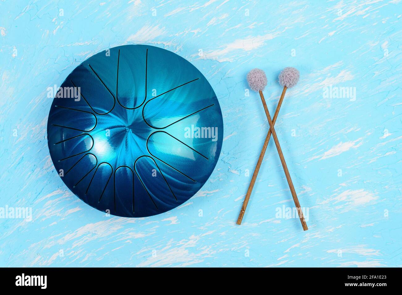 hang musical instrument, glucophone. metal tongue drum, blue background. top view copy space Stock Photo