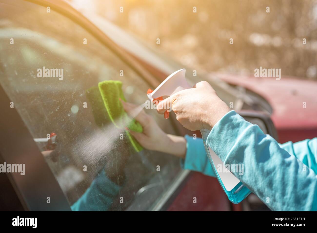 Clean the cockpit of the car with a spray Stock Photo - Alamy