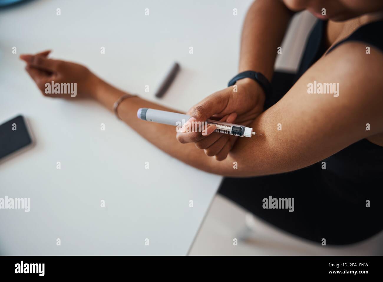 Afro American young woman doing vitamin injection Stock Photo - Alamy