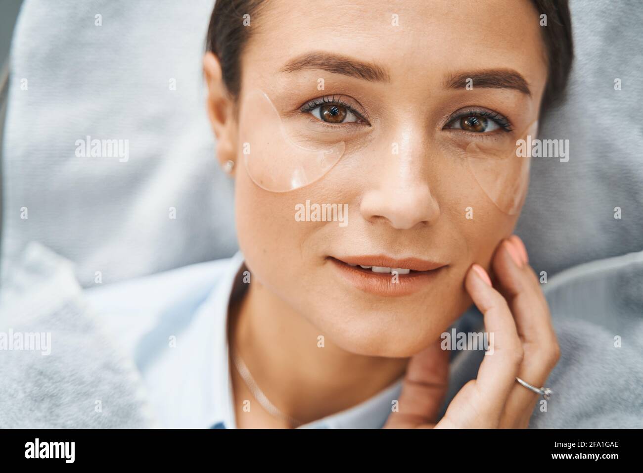 Beauty salon client with an eye mask Stock Photo Alamy