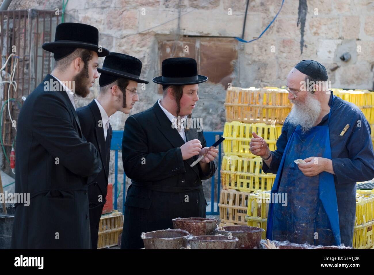 The butcher and rabbi examining the knife used to slaughter chickens. The are strict rules governing the use of the knife. Kaparot, an aged old Jewish Stock Photo