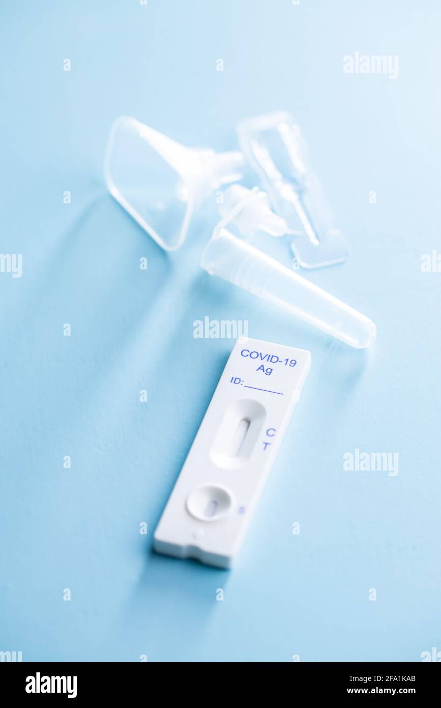 Covid-19 rapid antigen test. Rapid antibodies test kit on blue background. Stock Photo