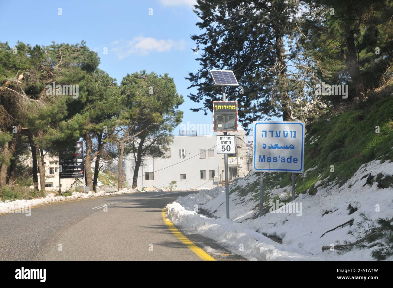 Israel, Golan Heights, The Druze vilege Massade (or Mas'ade) The welcome sign in English Arabic and Hebrew Stock Photo