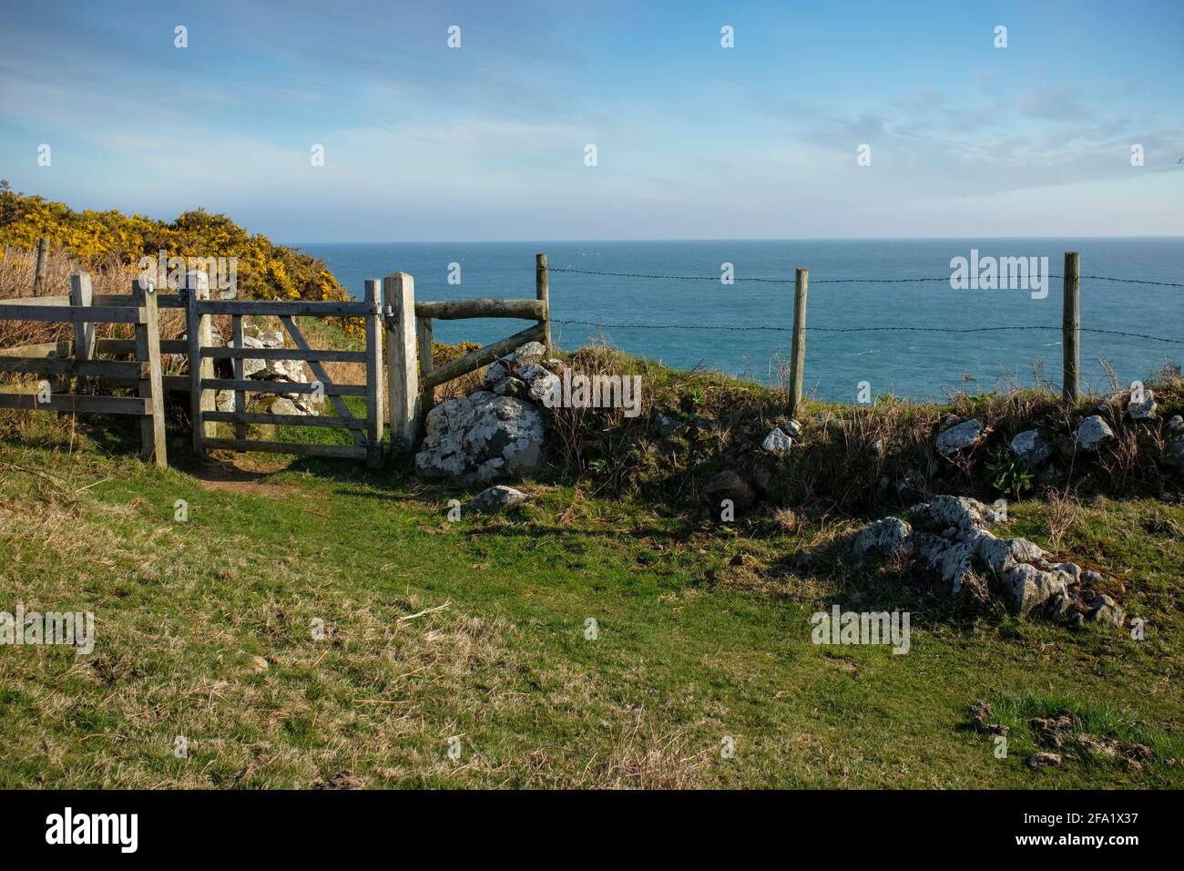 Stone wall and wooden swing gate along the Pembrokeshire Coast Path. Stock Photo