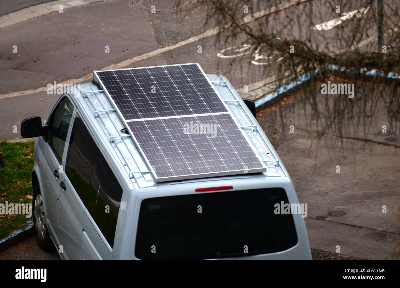 A VW Volkswagen Van with a solar panel on the roof. Austria, Europe Stock Photo