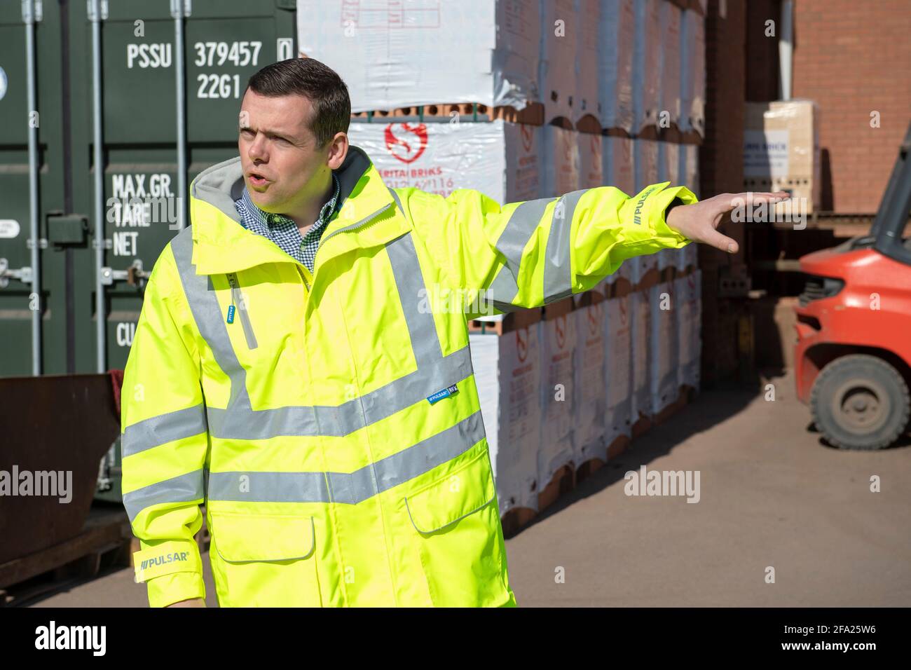Blantyre, Scotland, UK. 22 April 2021. PICTURED: Douglas Ross MP, Leader of the Scottish Conservative and Unionist Party seen visiting Raeburn Brick Ltd in Blantyre, a construction company to highlight the party's plans to create jobs and rebuild Scotland. Scottish Conservative plans for rebuilding Scotland's economy would create hundreds of thousands of jobs over the next Scottish Parliament term. Analysis by the party found their manifesto proposals could deliver at least 200,000 new jobs. Credit: Colin Fisher/Alamy Live News. Stock Photo