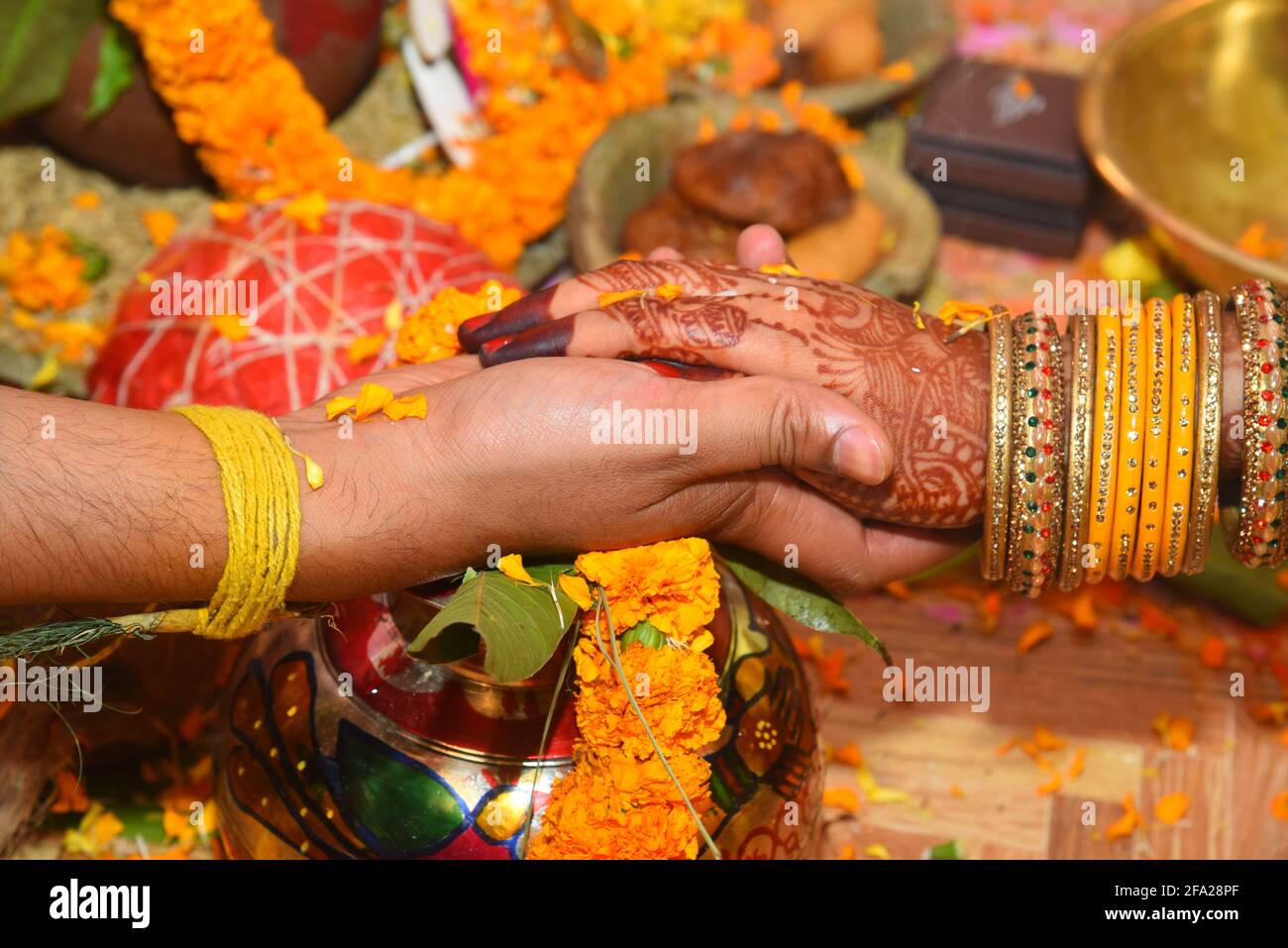 An Indian bride and groom holding their hands during a Hindu wedding ritual  Stock Photo - Alamy