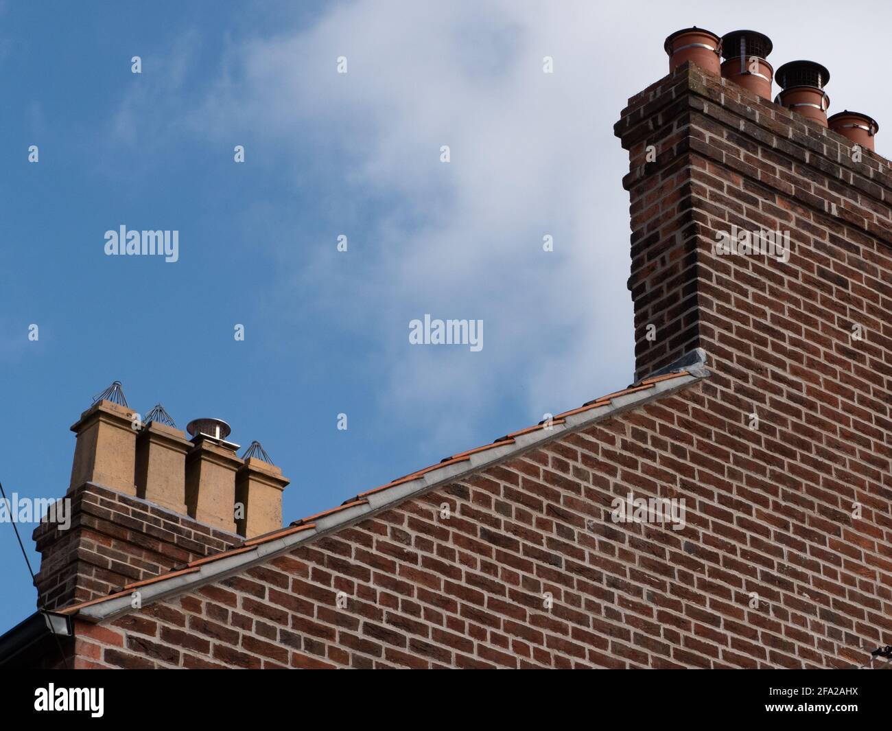 Chimney stack on a gable end of a brick but house in Westbury, Wiltshire, England, UK. Stock Photo