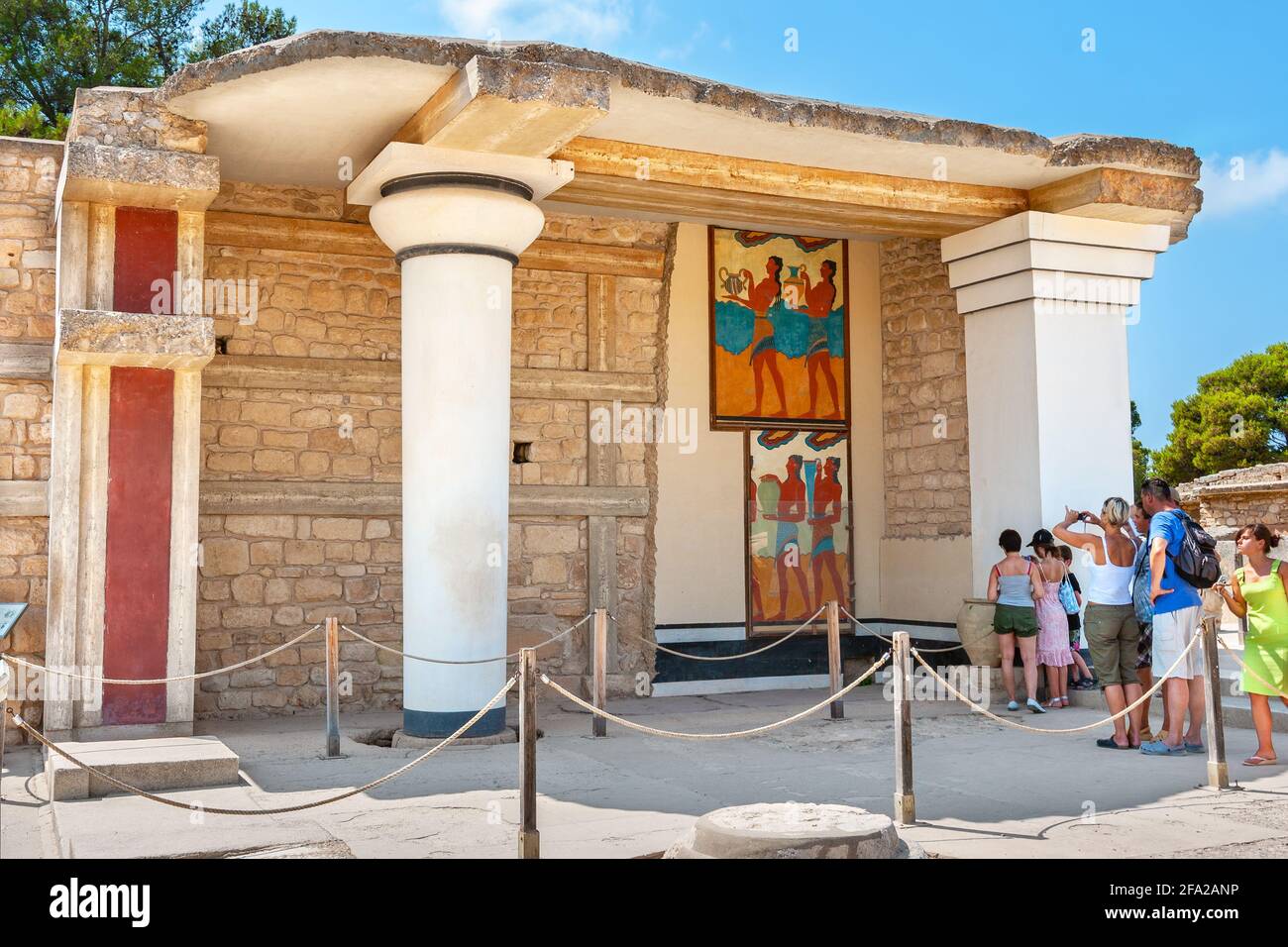 Tourist on a guided tour in Knossos palace near south Propylaeum with procession fresco. Crete, Greece Stock Photo
