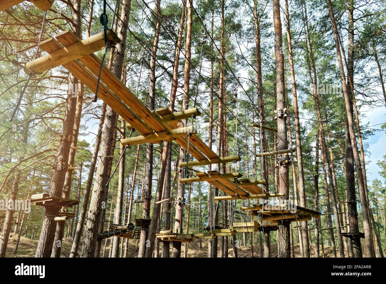 rope obstacle track high in the trees in adventure park Stock Photo