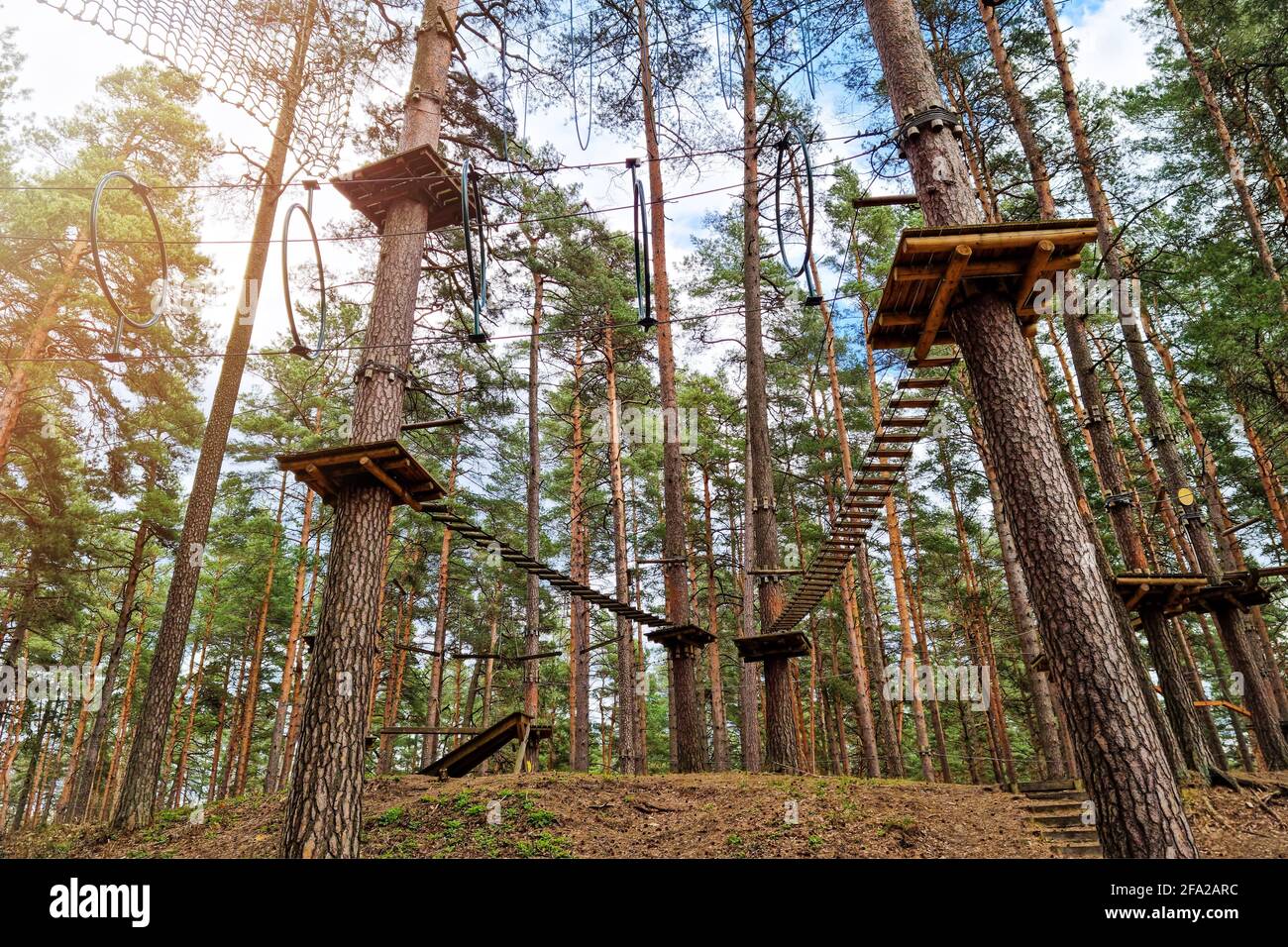 rope obstacle track high in the trees in adventure park Stock Photo
