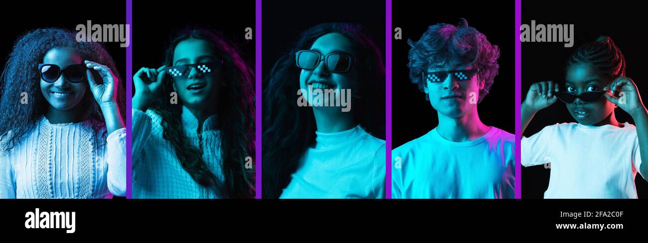Five young male and female models isolated on dack background in neon light Stock Photo
