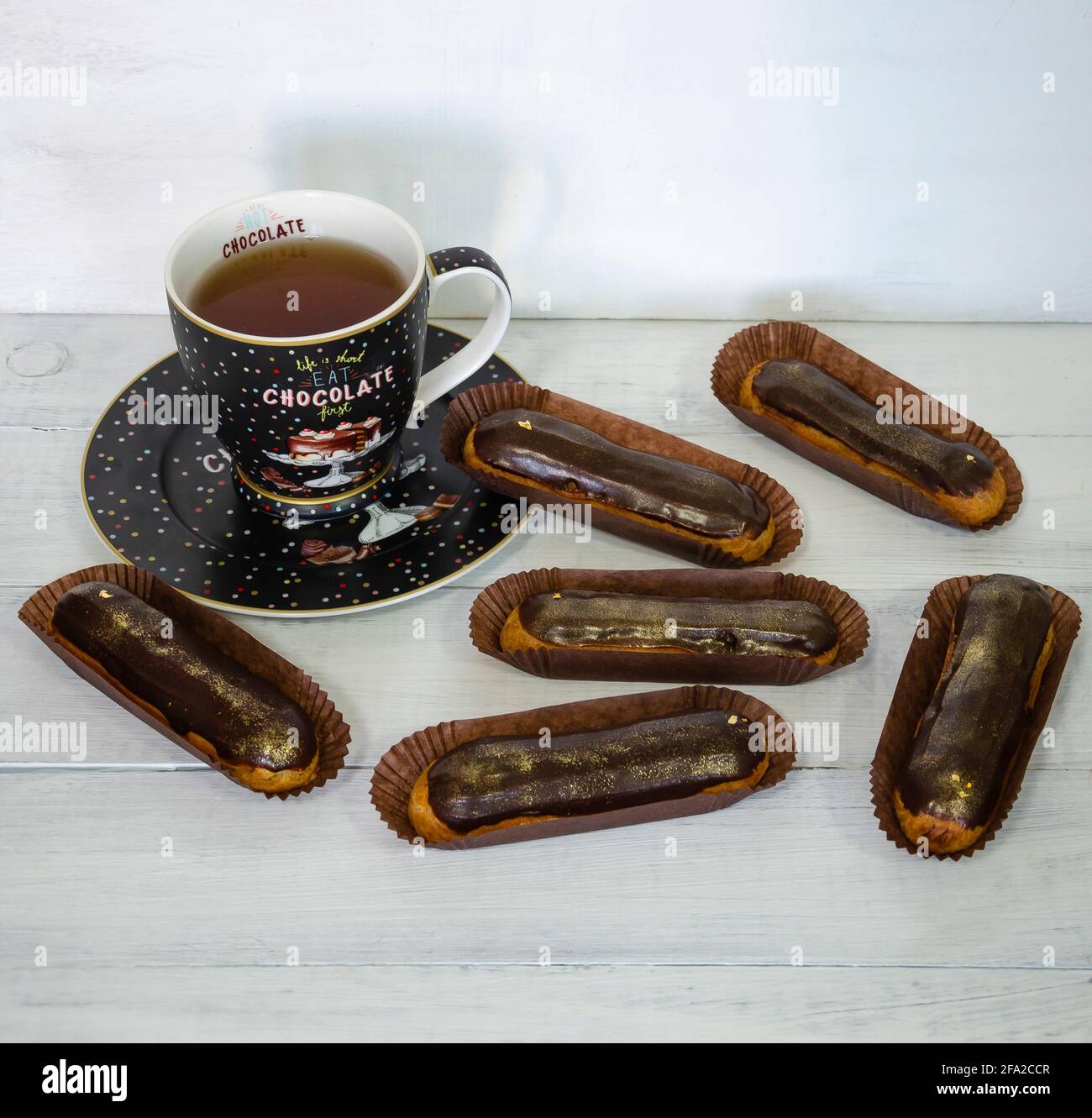 Gorgeous extra chocolate eclairs with gilded glaze Stock Photo