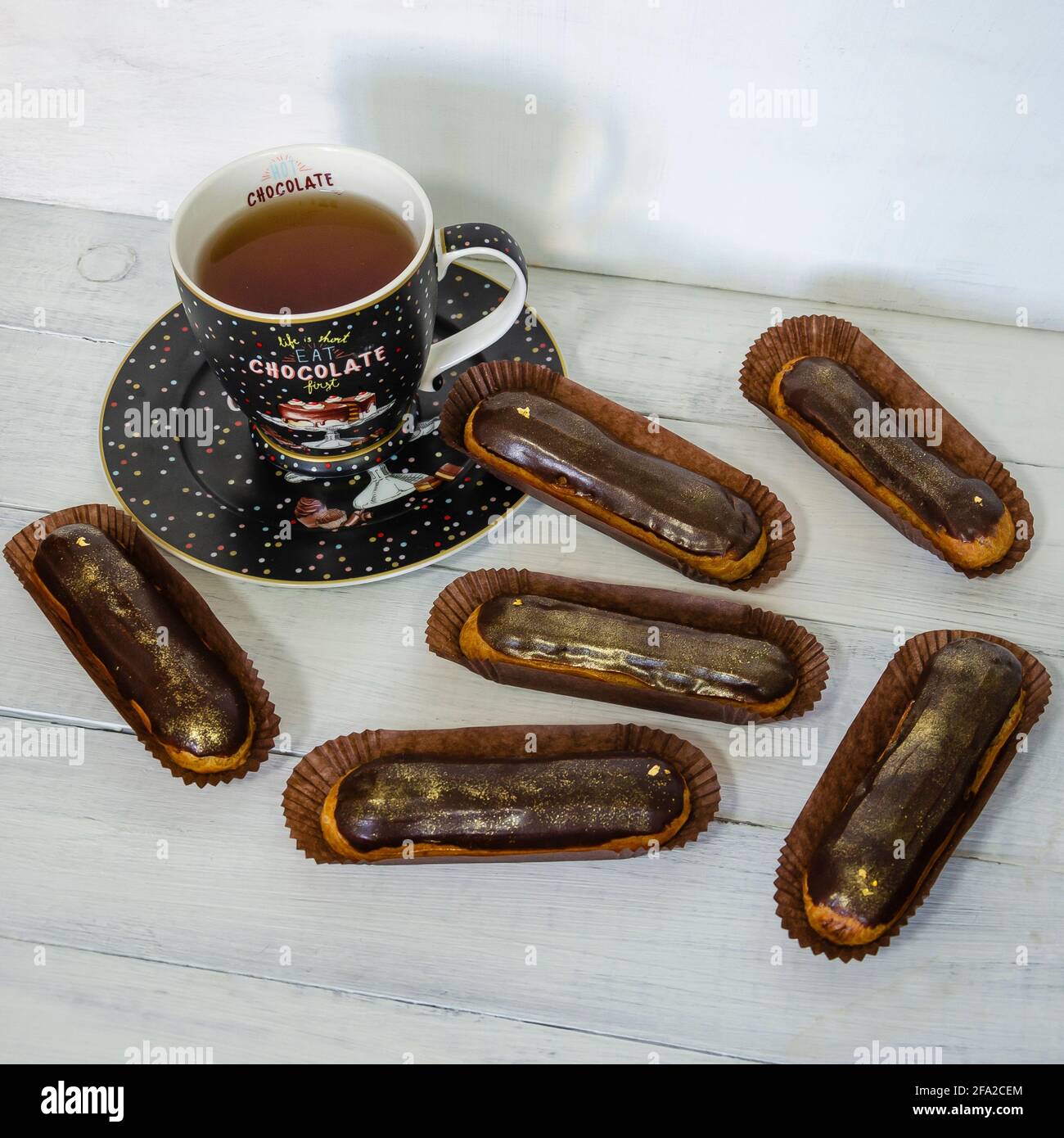 Gorgeous extra chocolate eclairs with gilded glaze Stock Photo