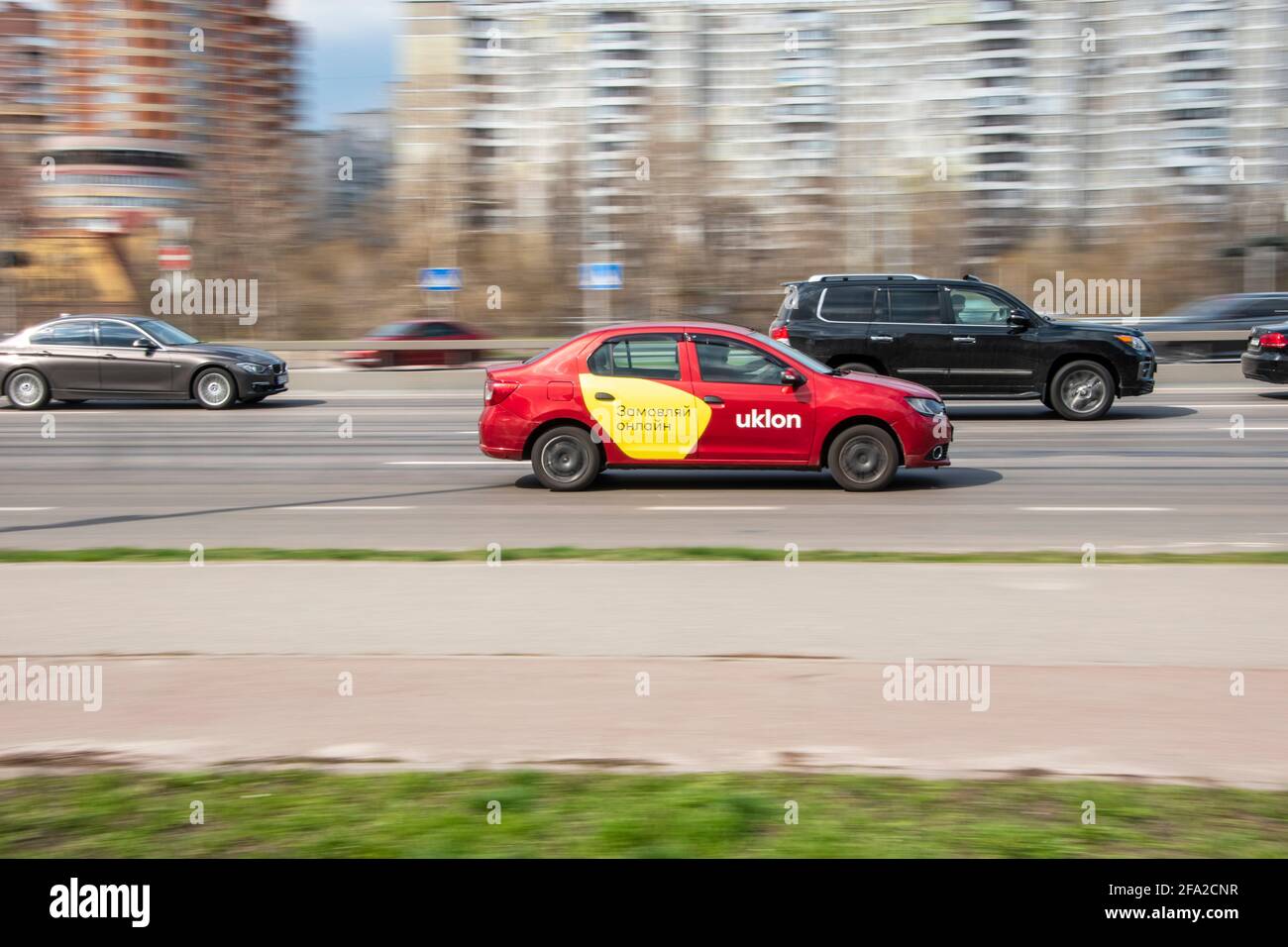 Ukraine, Kyiv - 6 April 2021: Taxi Uklon Red Renault Logan car moving on the street. Editorial Stock Photo